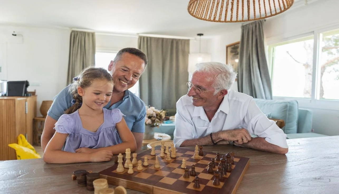 Focused young student practicing chess independently at home with a board and pieces.